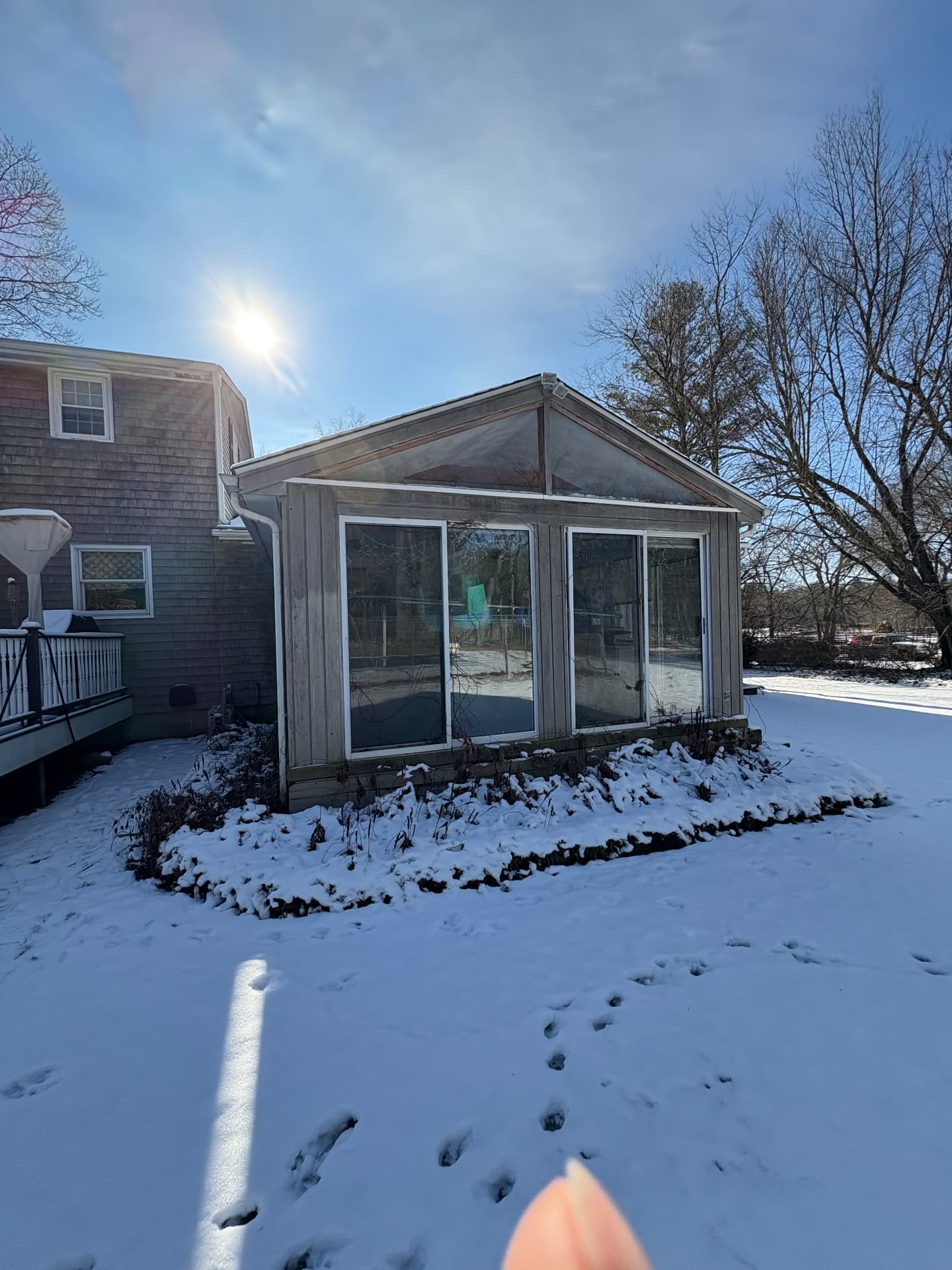 136 Rustic Acres — dated sunroom exterior